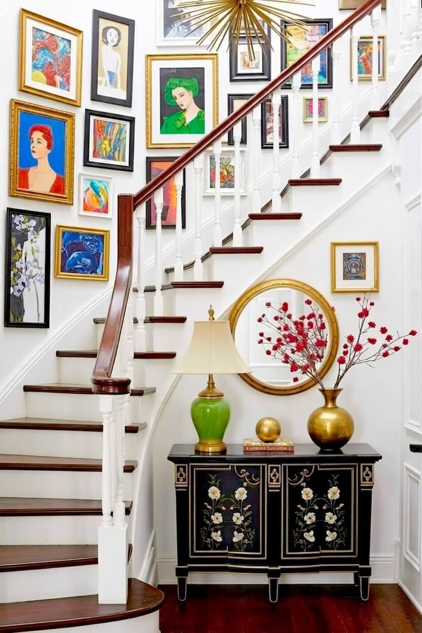 A vibrant assortment of colorful expressionist portraits and abstract paintings in ornate gold and black frames covering a white wall for artistic stair decor.