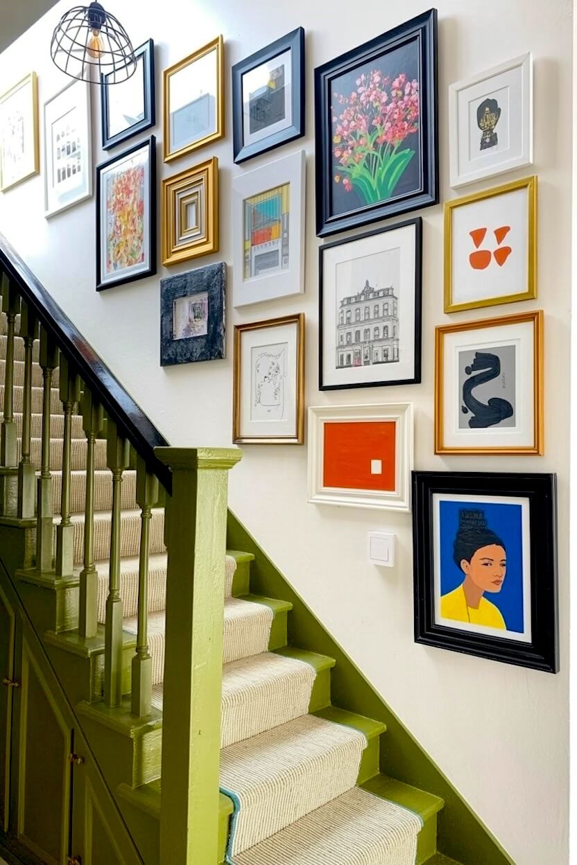 A dynamic collection of contemporary abstract shapes, architectural sketches, and vivid portraits in mixed frames displayed as a bright modern stair wall gallery.
